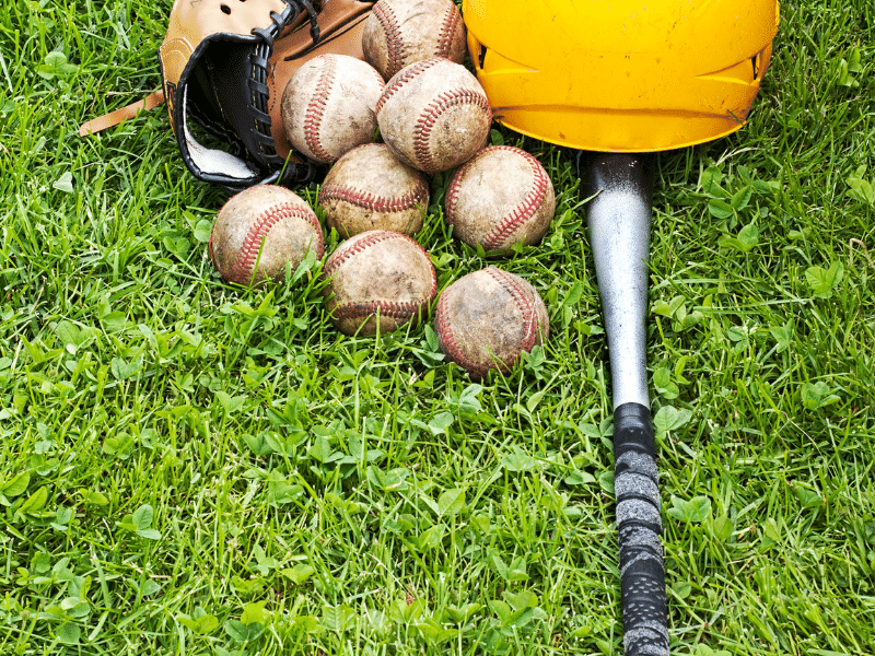 Baseballs and bat on the ground