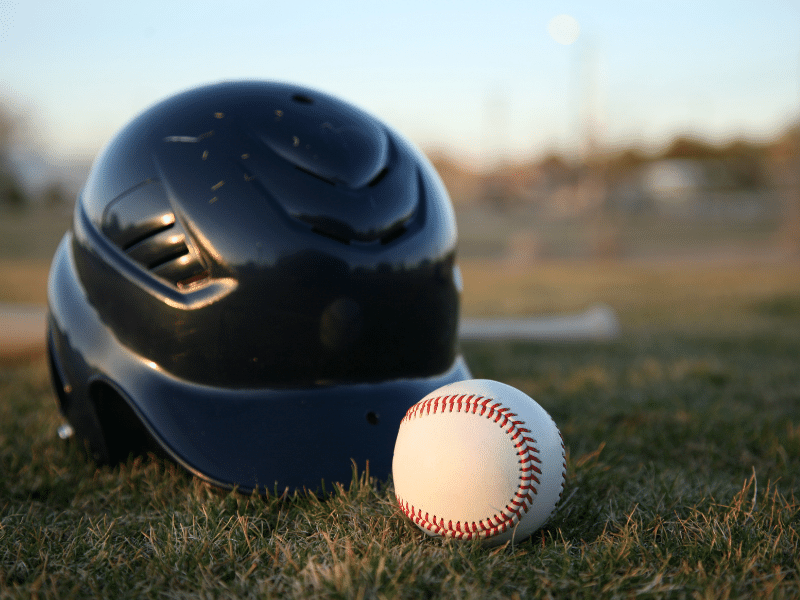 helmet and a baseball on the ground