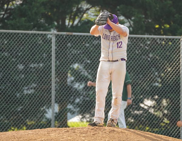 A Man in White and Purple Baseball Jersey